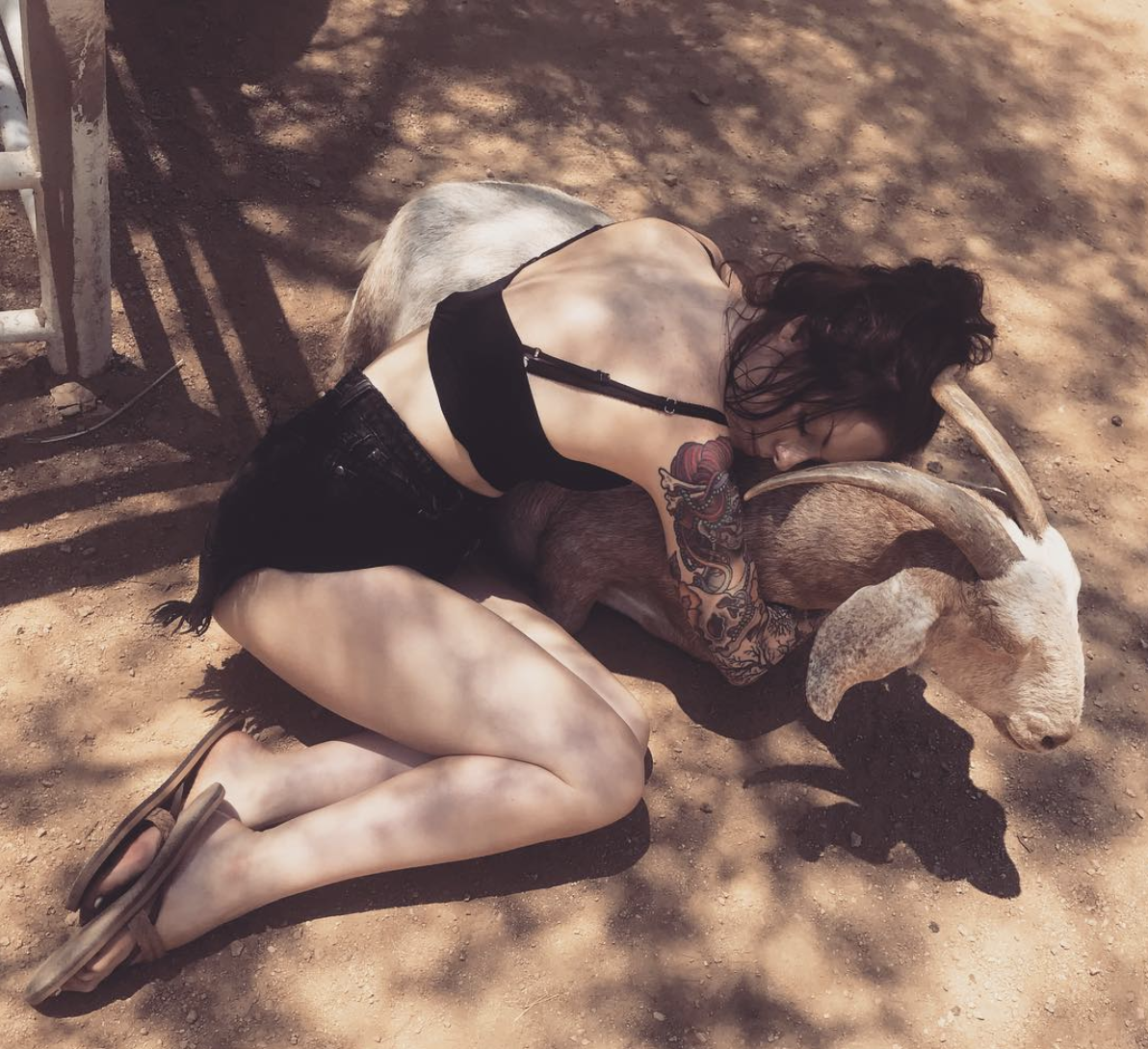 Victoria Eden lying with goat
